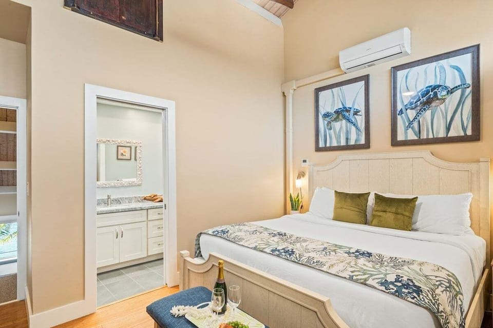 Second bedroom with king bed, ceiling fan, and calming coastal décor.