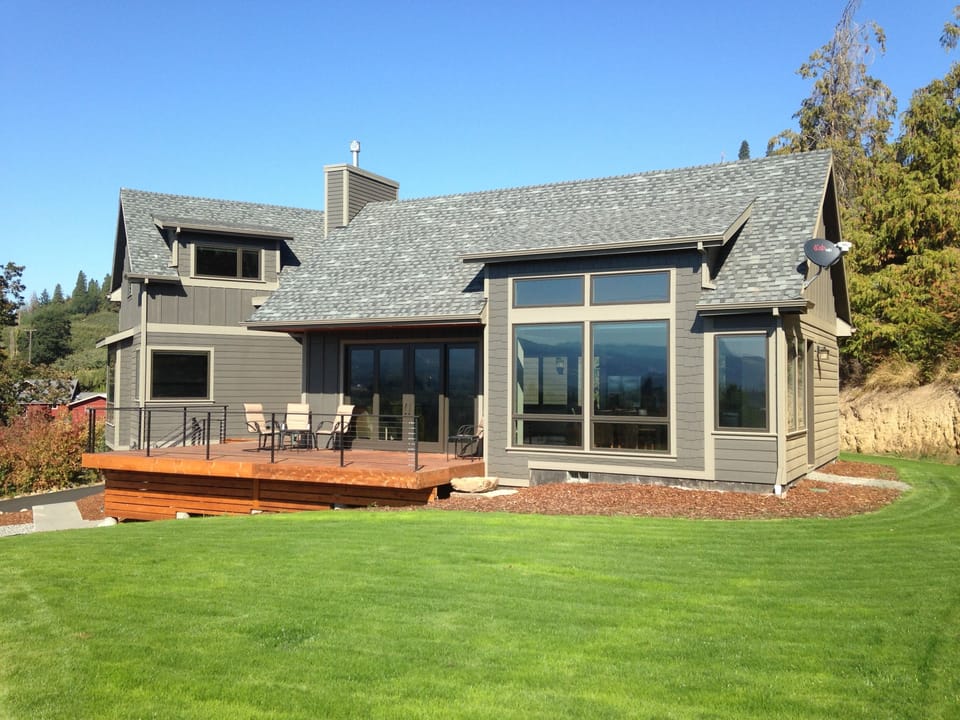 Front and side yard. Front deck and large, dining room windows.