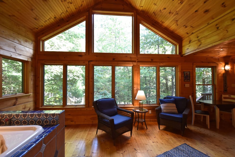 A beautiful sunroom with a view out into the private yard. 
