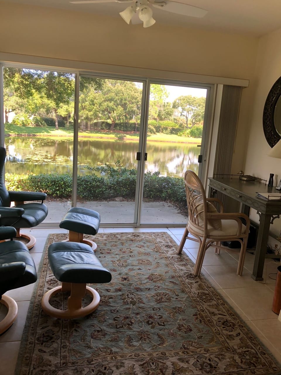 Sunroom with desk and printer.  2 stressless recliners with ottomans.