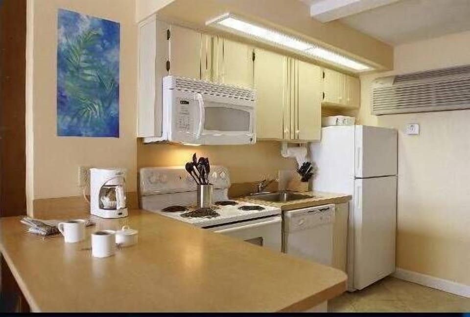 Full kitchen complete with appliances, utensils and dishes