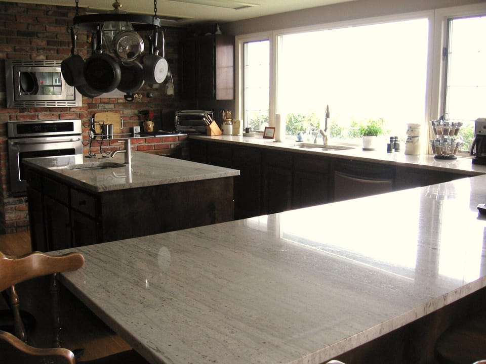 Kitchen with Granite counters, island, eating bar and views of the water