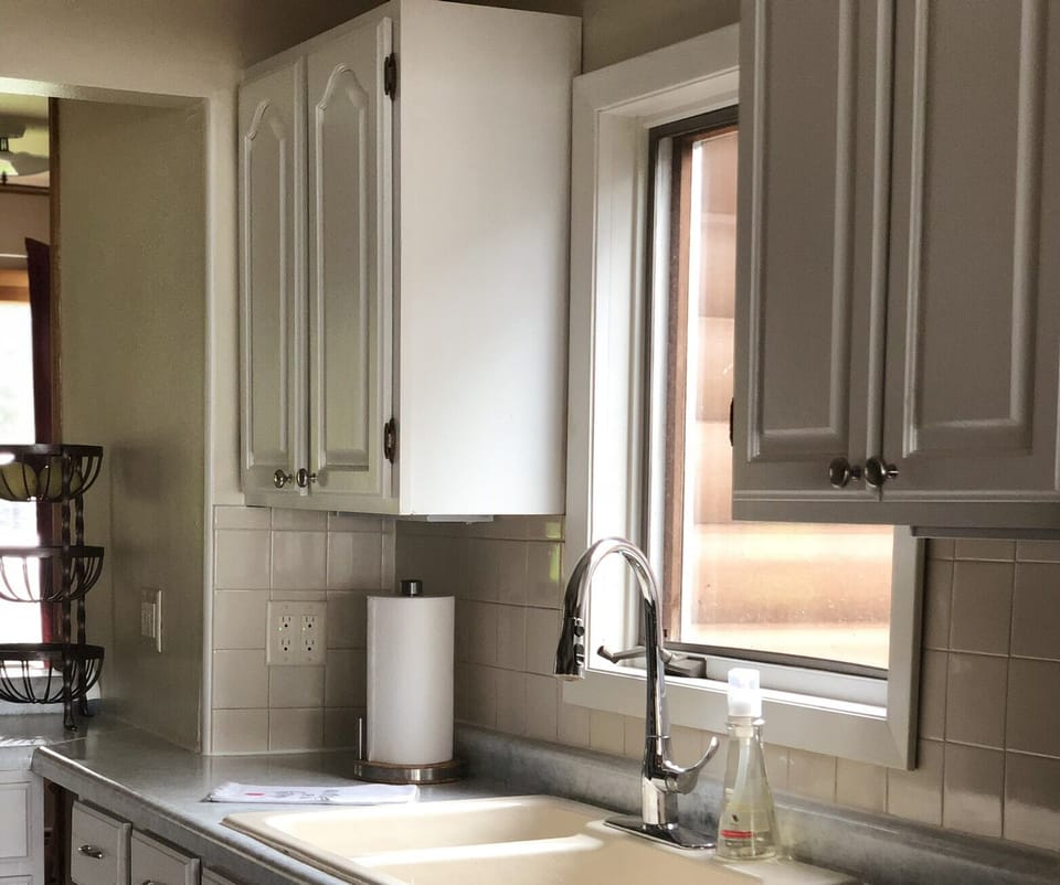 The kitchen leads into the living room with a lake view.