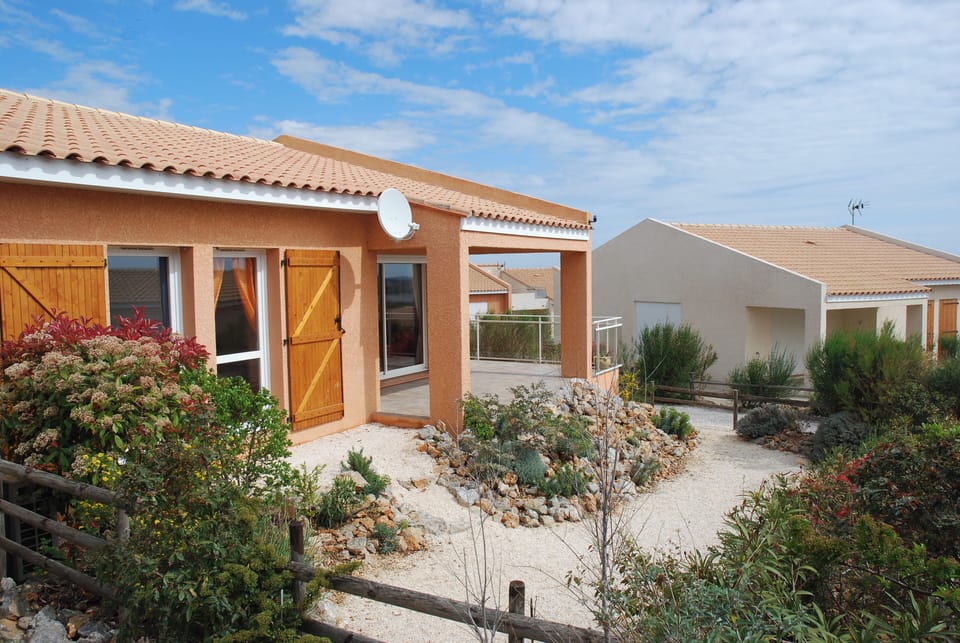 Rear of villa with covered terrace (side terrace is uncovered). Gas BBQ.