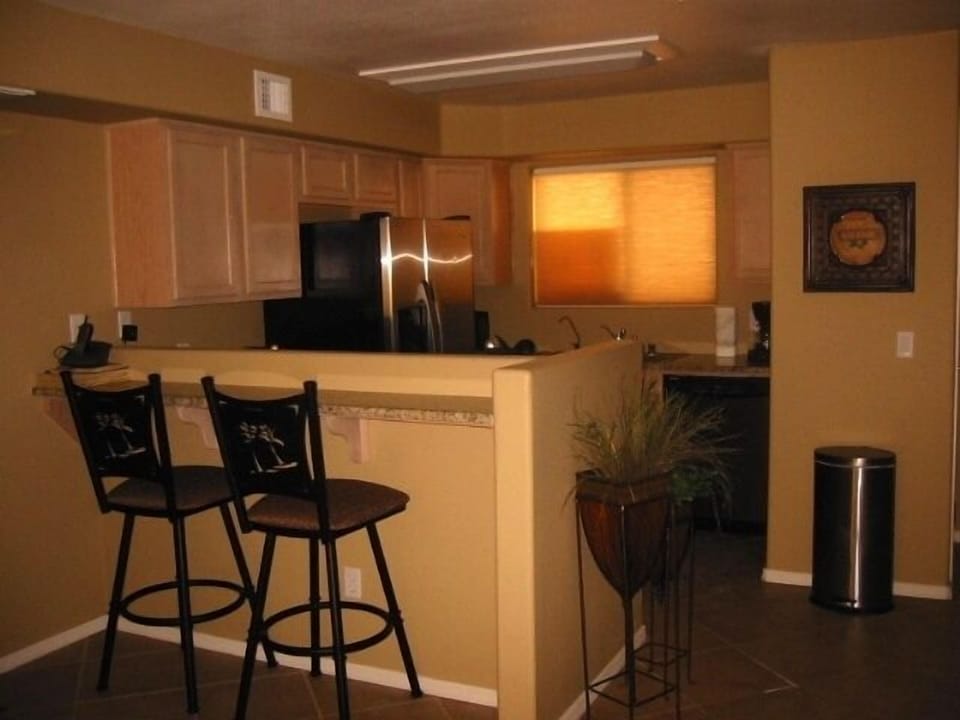 Fully functional kitchen with stainless appliances and bar seating