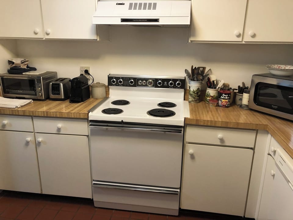 Kitchen with microwave, Nespresso espresso maker, toaster, and toaster oven
