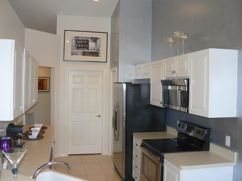 Kitchen with lots of cupboard space, vaulted ceiling, pantry and laundry room.