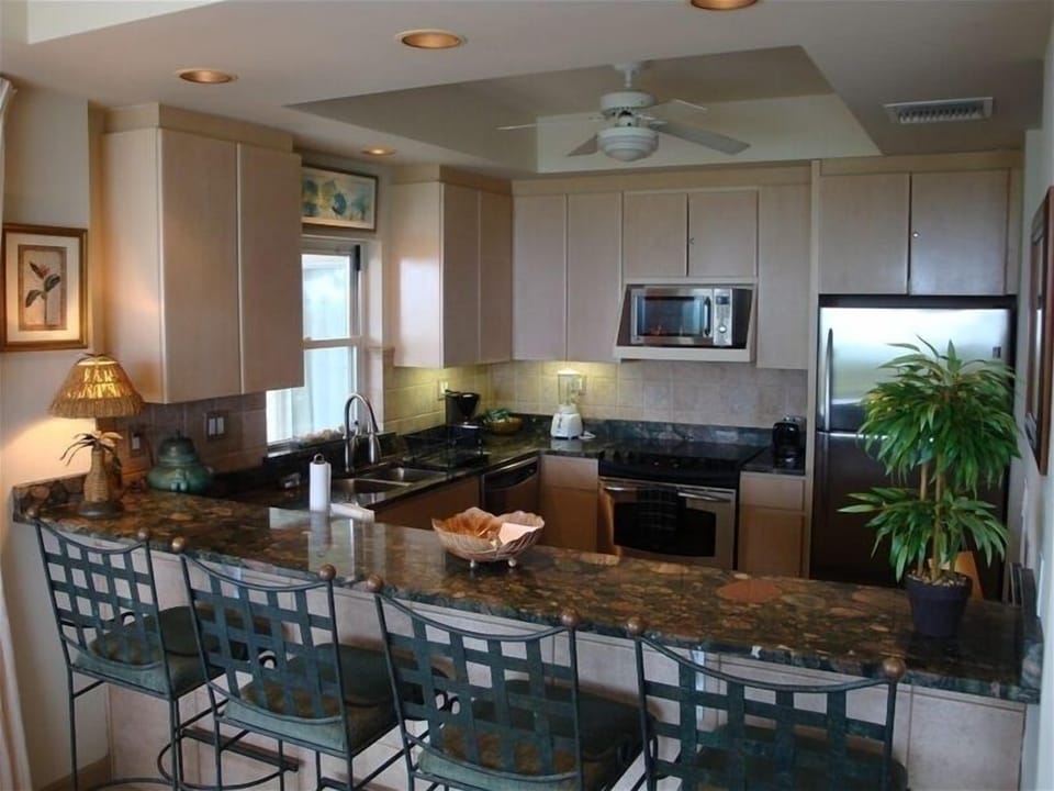 Kitchen with granite counter-tops and stainless steel appliances