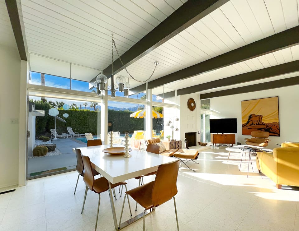 Large walls of glass out to the pool and backyard from dining and living rooms