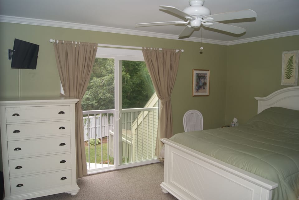Master bedroom - newer TV, furniture, slider, paint, carpet and moldings.