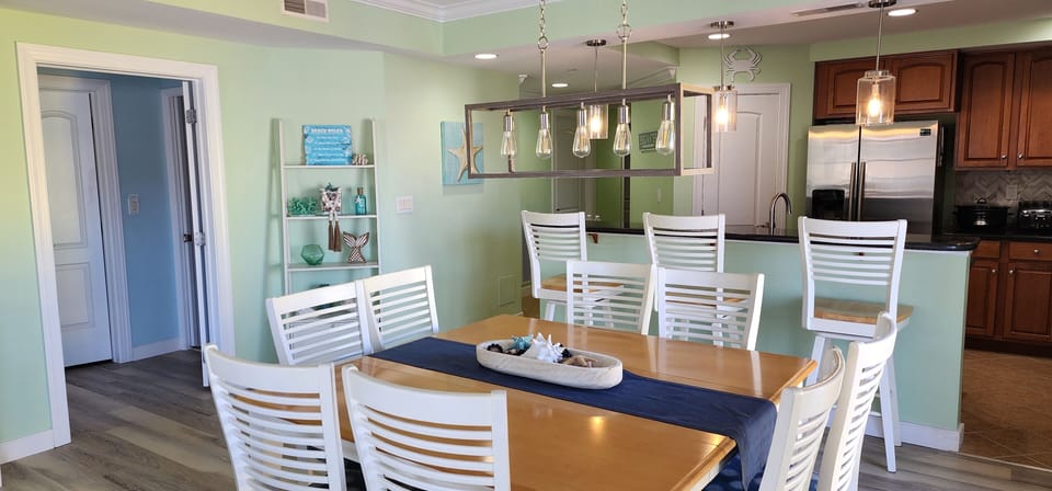 Large dining table to fit 8 hungry guests and 3 bar stools at breakfast bar. 