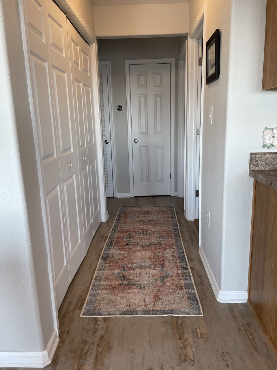 Hallway to full size washer/dryer, main level bathroom and two bedrooms.