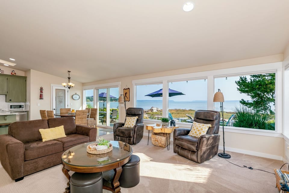 Large living room with a sweeping view of the Livingston Bay and Mt Rainer.