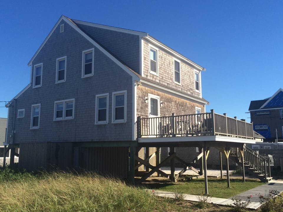Back of house with spacious deck and gas grill
