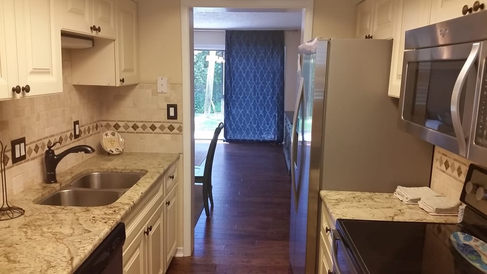 View from Kitchen into living area with all new stainless steel appliances