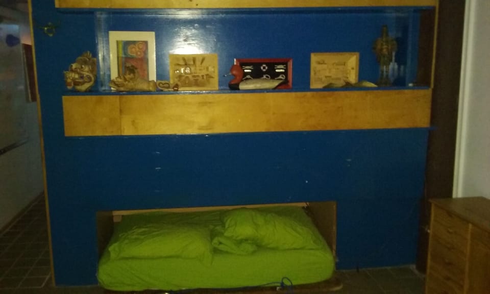 Queen bed in North bedroom with bunks - slides out