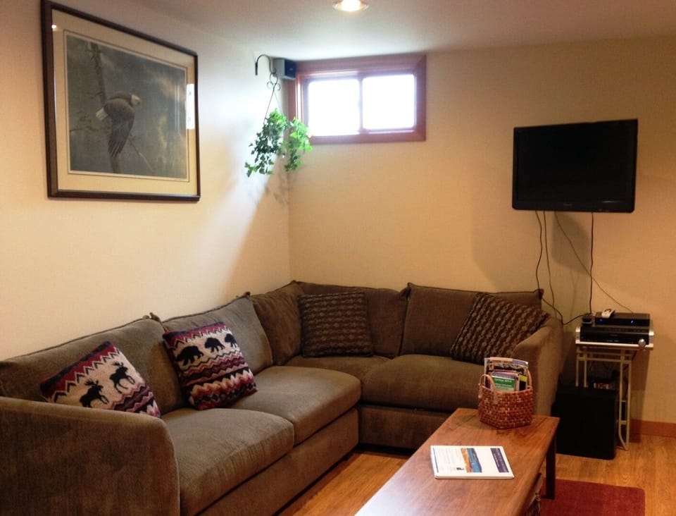 Sectional and flat screen television with Direct TV as provider.  