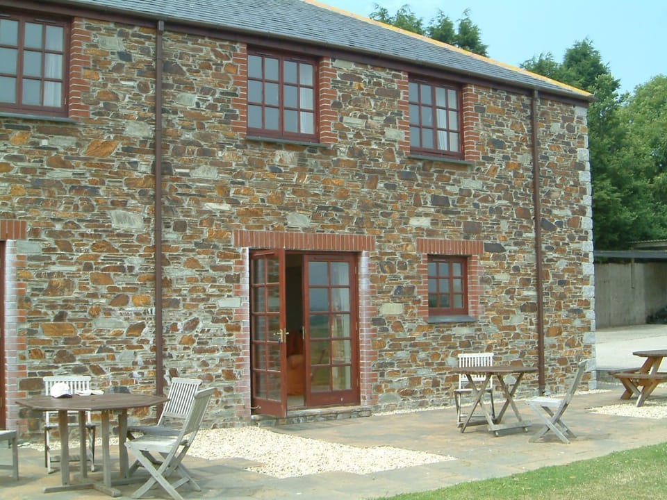 Photo shows the patio area which has a separate outside table for each cottage 