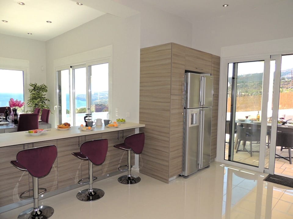 Zeus Bay American style refrigerator/freezer & doors to dining and pool terrace.