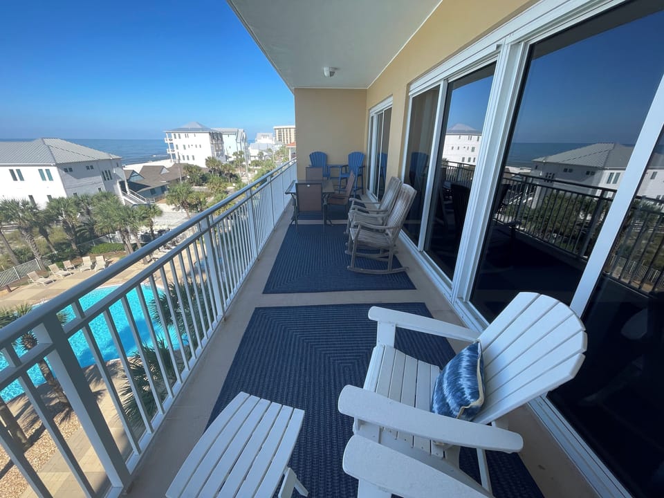 Large balcony with plenty of seating and dining table
