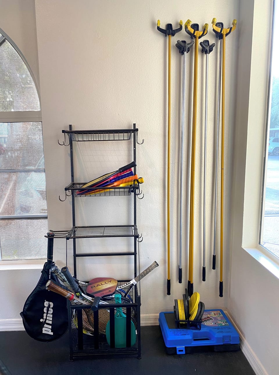 Picke ball and tennis rackets are stored inside the exercise room.