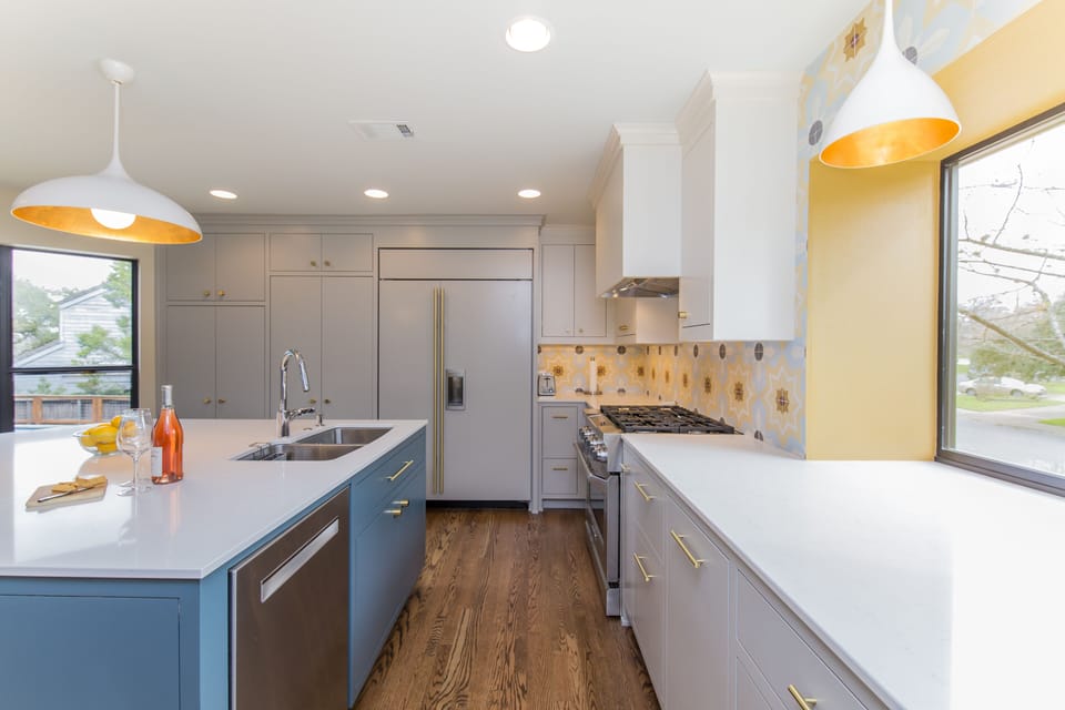 Sub-zero fridge with custom cabinetry and lots of counter-top space for cooking