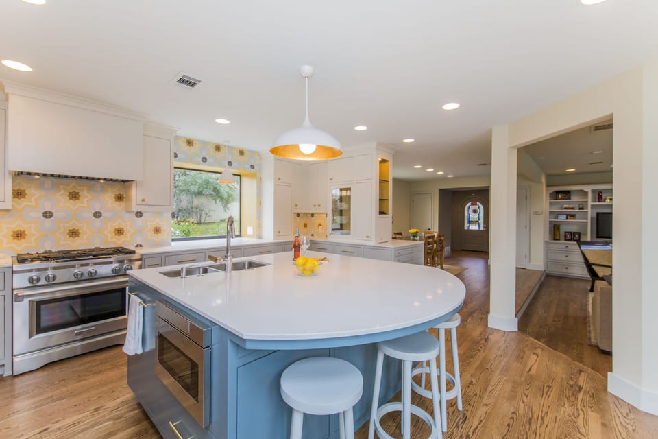 Large island in newly remodeled kitchen, wine fridge, great for gathering.