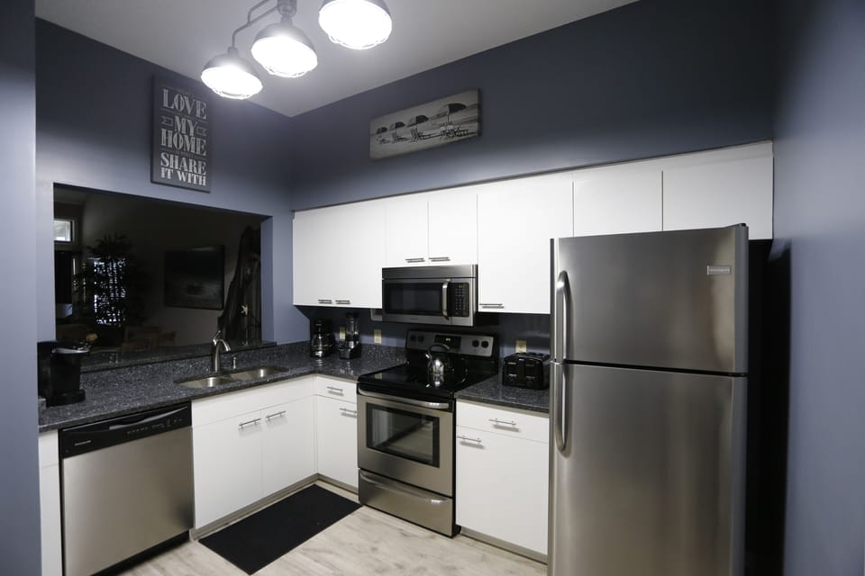 New stainless steel appliances, newly painted with brilliant Blue Pearl granite
