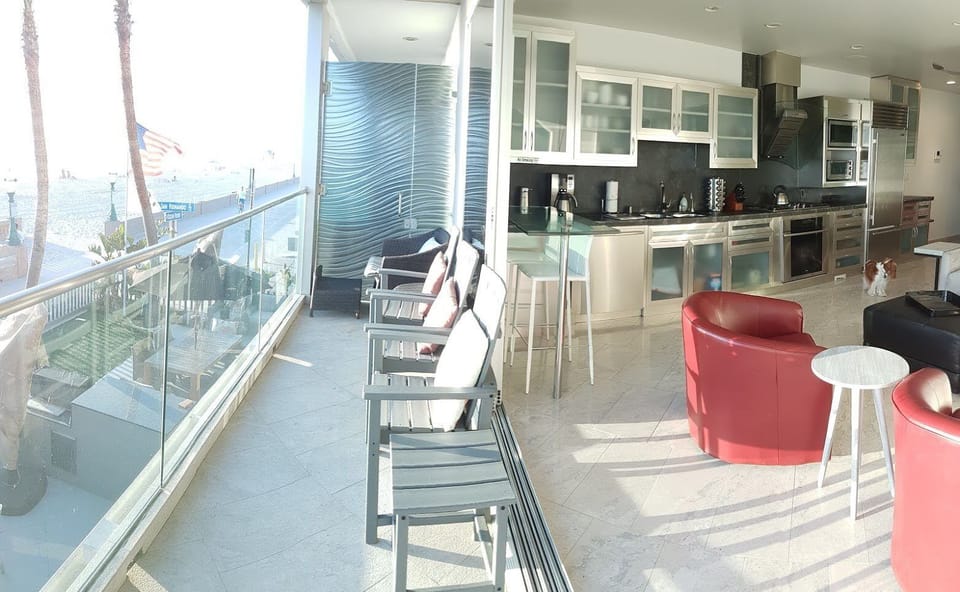 Large sliding windows open the living area to the beach.