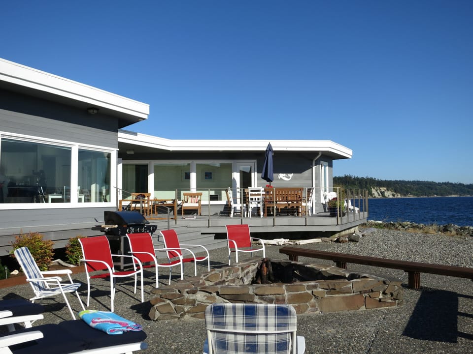 Here is another view of the outside including spacious deck, patio and fire pit.