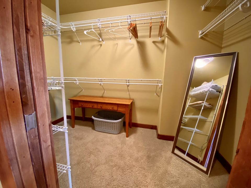 Walk-in closet with full length mirror in master bedroom