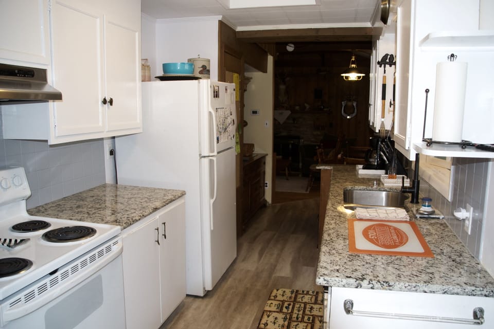 Kitchen looking toward den. There are new stainless appliances since this pix.