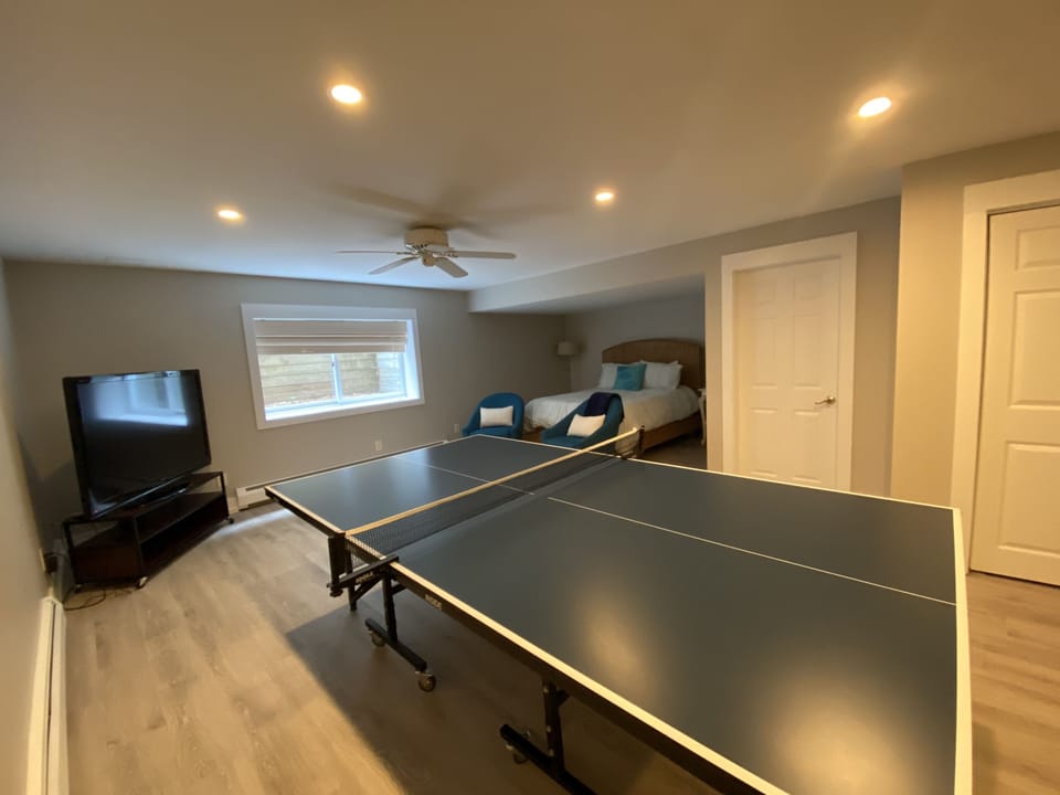 Basement bedroom features ping pong table