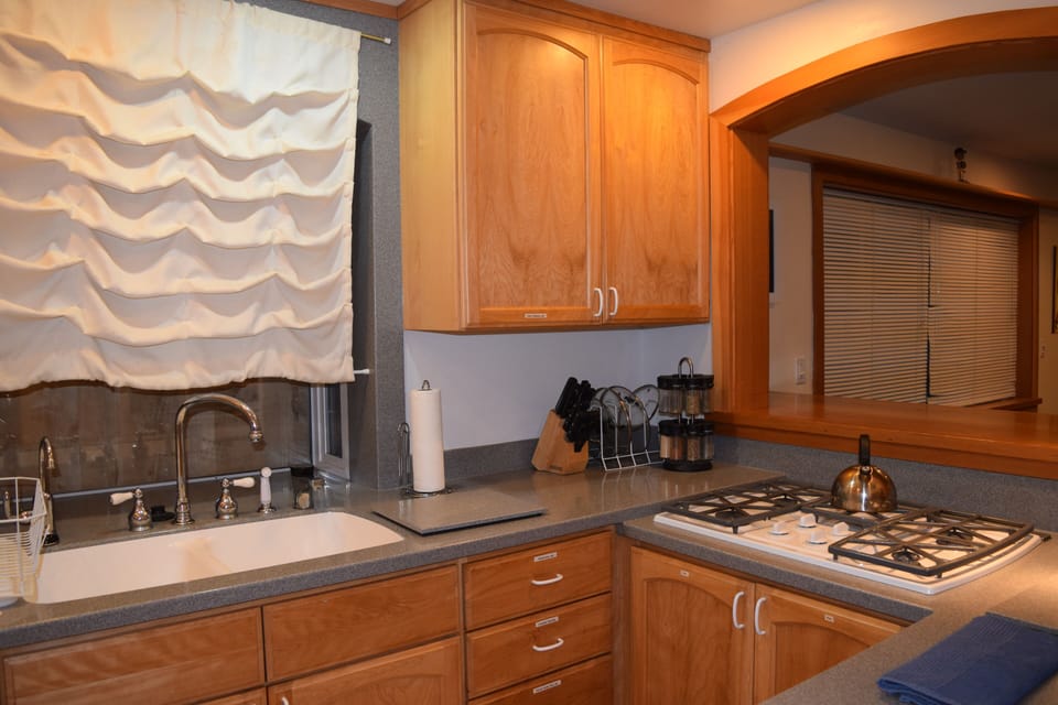 Fully functional kitchen with breakfast bar, spices, pans, bowls, toaster etc.