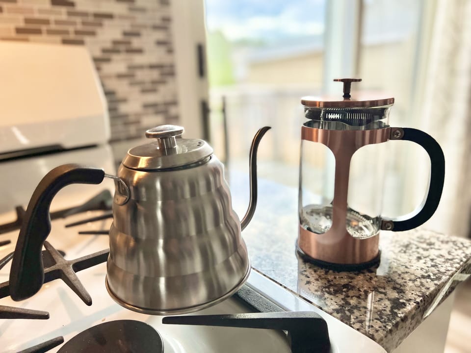 French press and kettle with thermometer included as coffee brewing options 