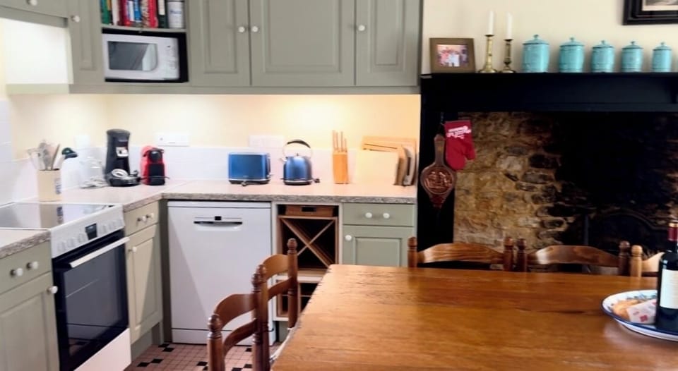 Fully stocked kitchen with multiple coffee makers and kitchen gadgets. 