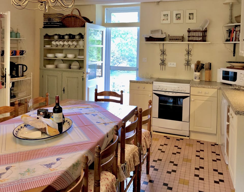 Kitchen with screen doors to back terrace and garden