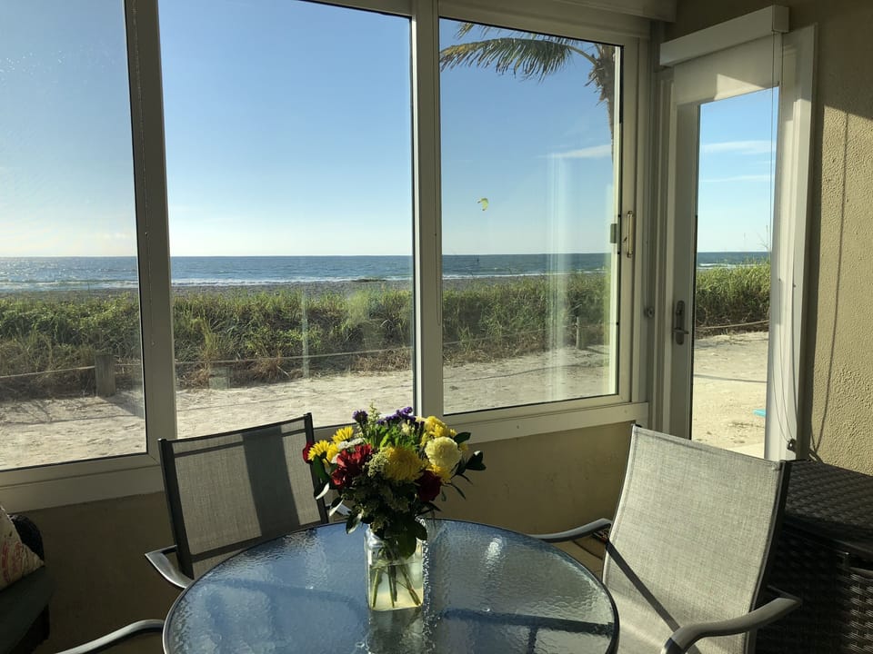 Full Glass Lanai Door Leading to Beach and Outside Patio