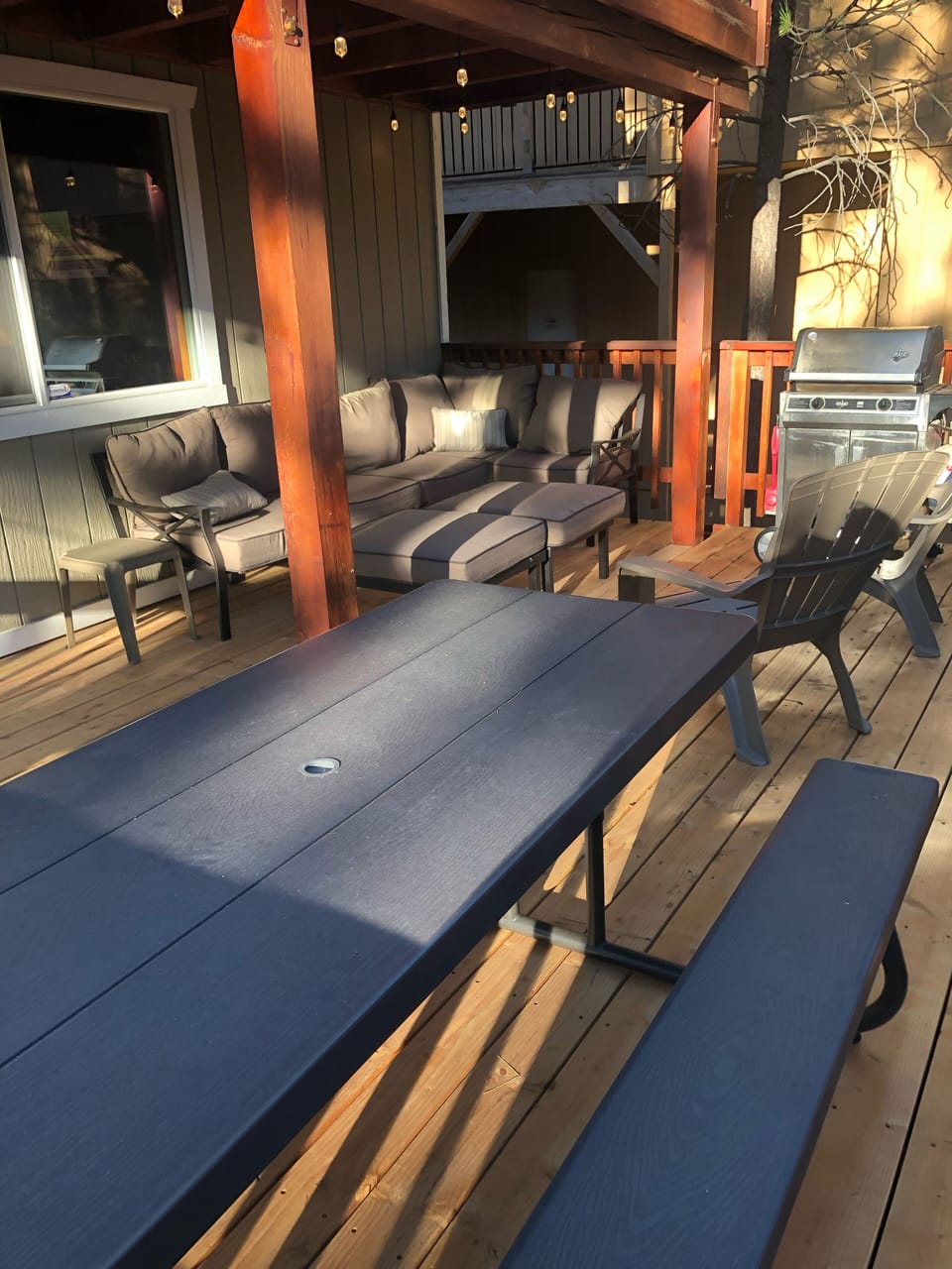 Large deck with BBQ , picnic table, and outdoor couch 