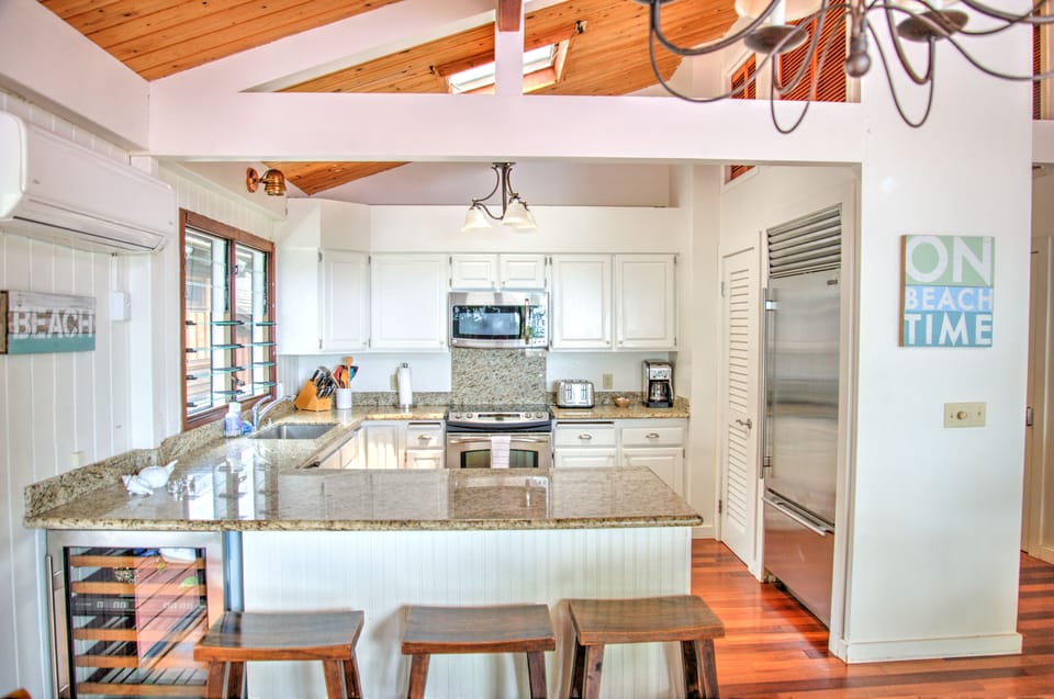 View of kitchen from dining room,  with toaster, microwave, and coffee maker