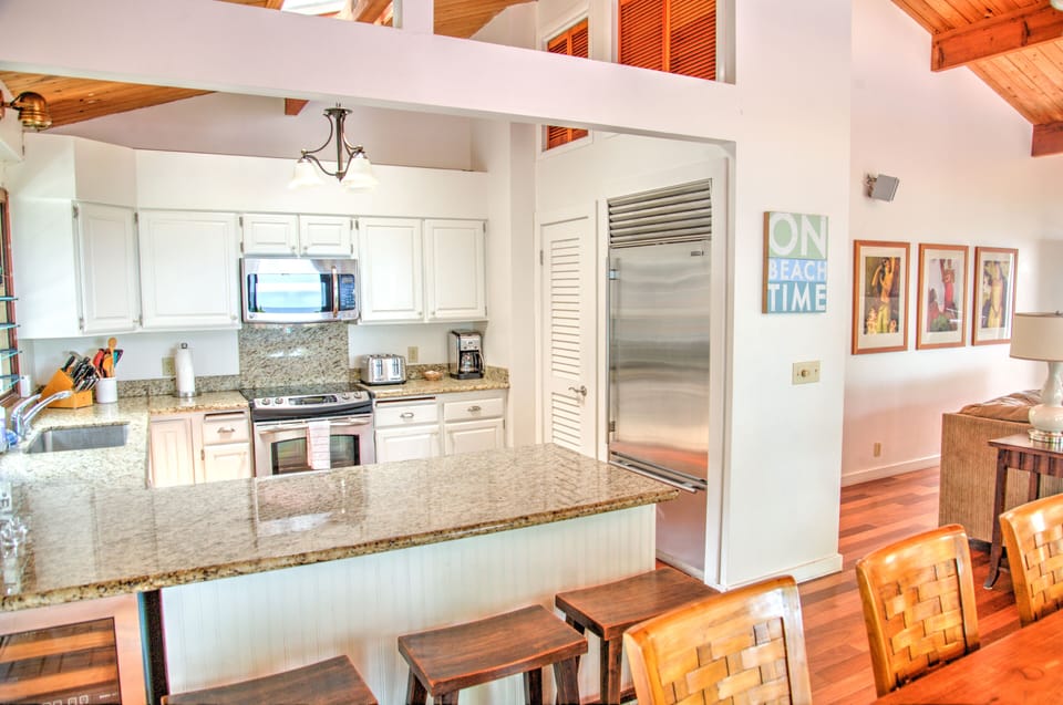 Kitchen with view of granite countertops and bar stools.  