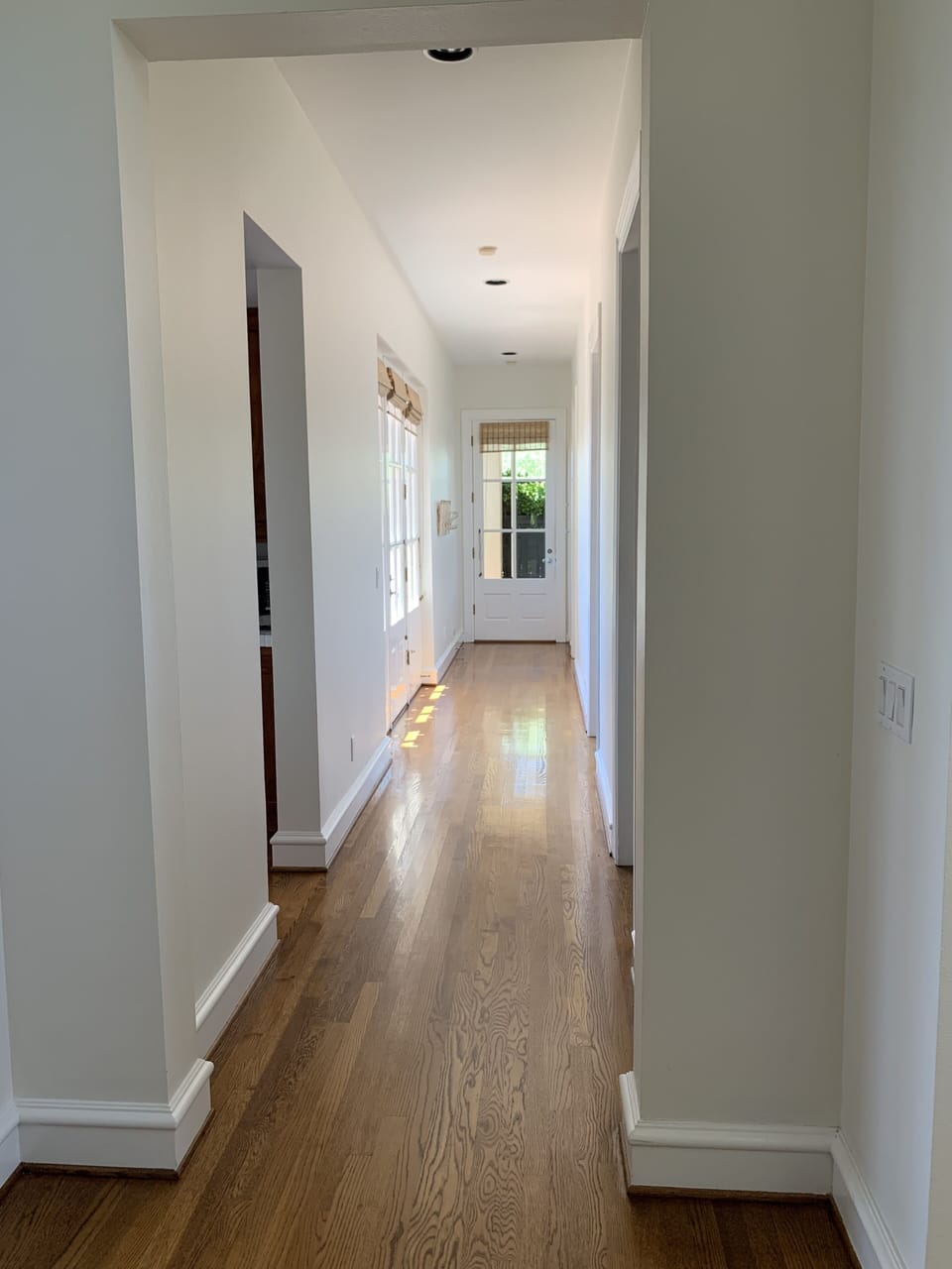 Hallway with French doors opening onto outdoor patio dining.