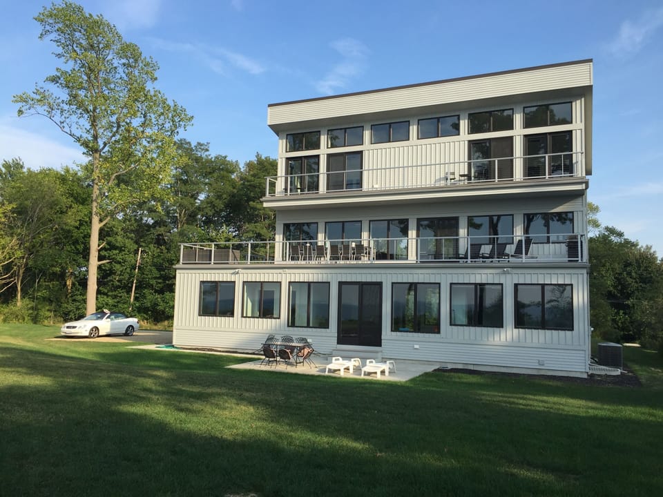 Lakeside with tons of windows, huge 2nd floor deck with couch, table, and grill.