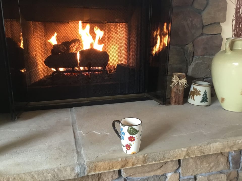 Enjoy a warm drink by the fireplace

