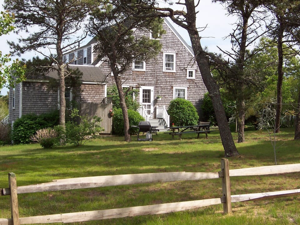 Looking toward kitchen over the large lawn area with picnic bench and grill area