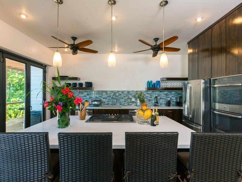 In the kitchen at Vivaro, the massive central island 🏝️ is designed as the primary social hub, comfortably seating 6 people on high-end barstools. It serves as a bridge between the gourmet cooking area and the rest of the Great Room.