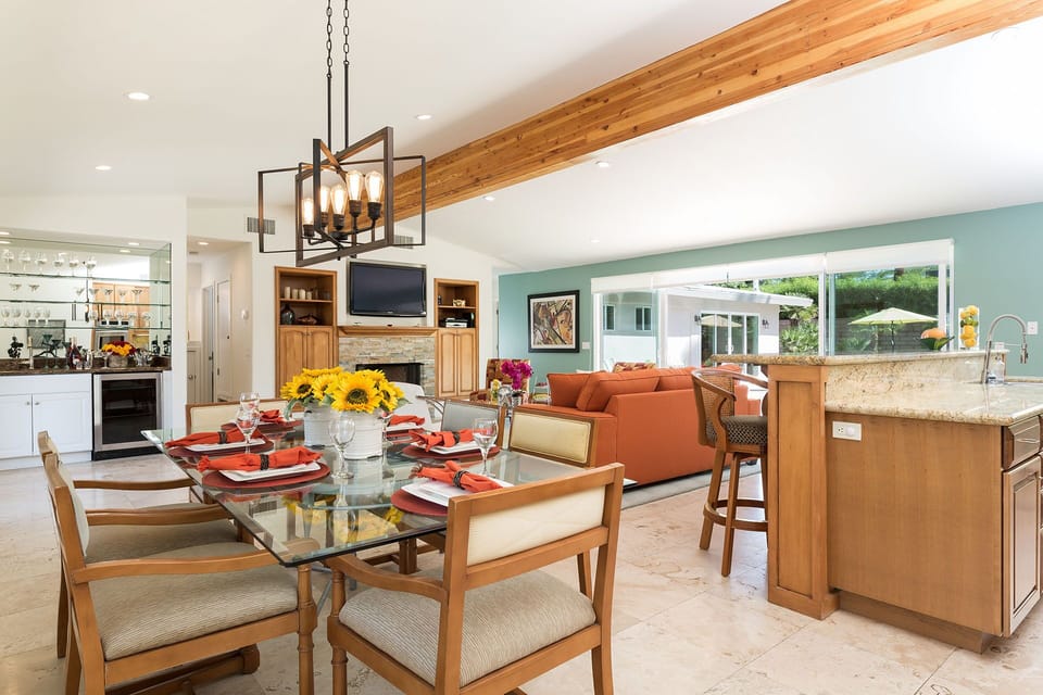 Dining table/chairs and additional seating at bar with pool views.