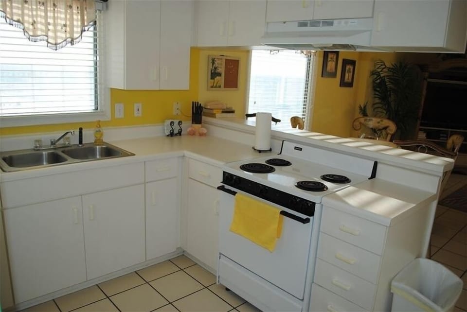 Fully equipped kitchen.  Notice the windows looking east on the bay.  