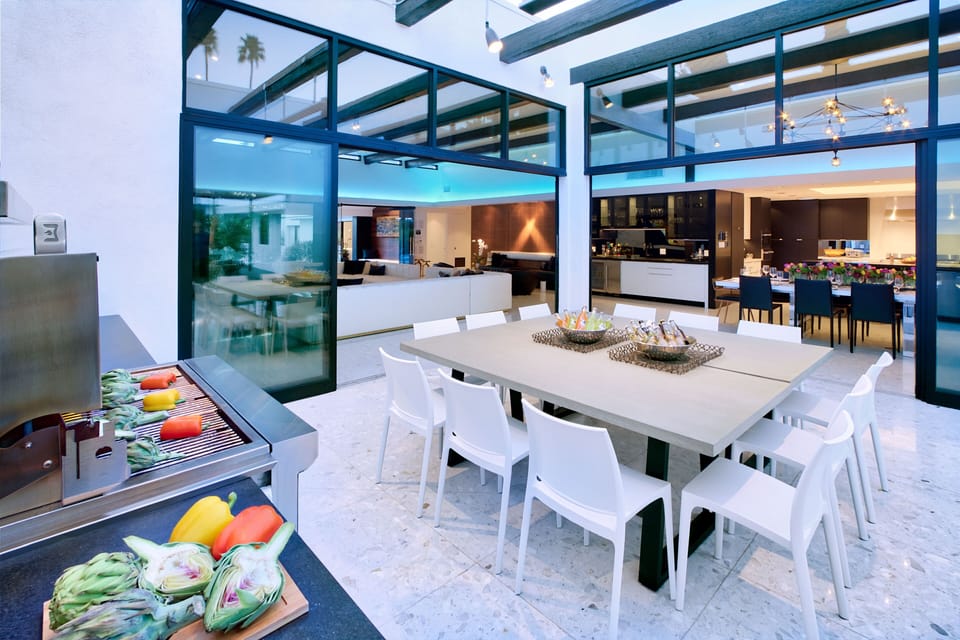 Outdoor dining/kitchen courtyard. Seats up to 16. Heater for chilly nights. Glass walls provide circular flow to great room and kitchen. 