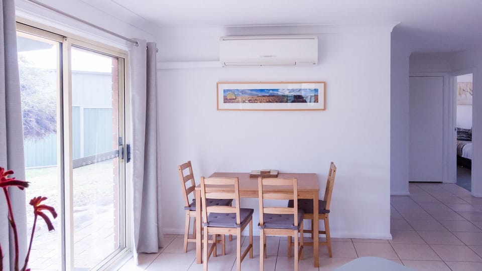 Dining table with seating for 4 plus AC unit.